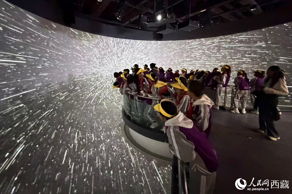 藏域星球天文體驗館中，小學生在沉浸式星空隧道里仰望璀璨星河，感受宇宙穿梭帶來的視覺震撼與科學魅力。人民網記者 次仁羅布攝